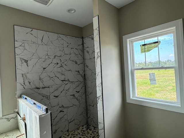 bathroom with tiled shower