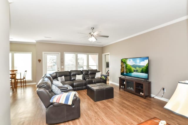 living room featuring ornamental molding, ceiling fan, and hardwood / wood-style flooring