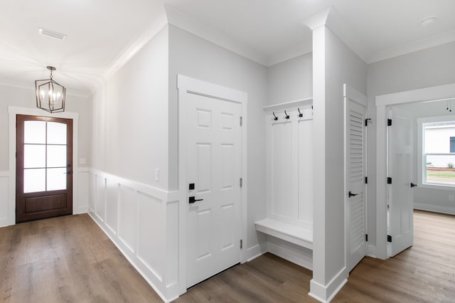 mudroom featuring crown molding, an inviting chandelier, and light wood-type flooring