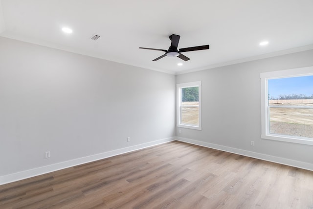 unfurnished room with crown molding, a healthy amount of sunlight, ceiling fan, and light hardwood / wood-style floors