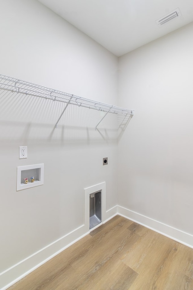 washroom with hardwood / wood-style flooring, electric dryer hookup, and hookup for a washing machine