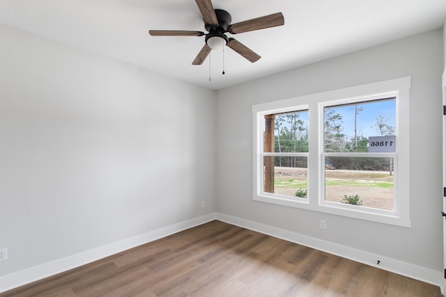 unfurnished room with ceiling fan and wood-type flooring