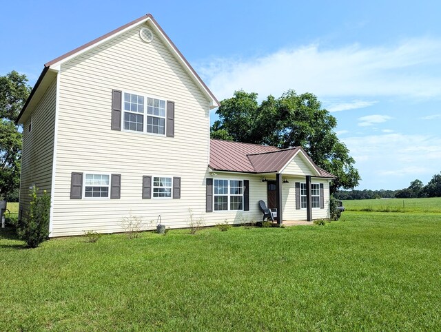 1370 Coach Rd, Slocomb, AL 36375 - view of front of house with a front yard and a metal roof