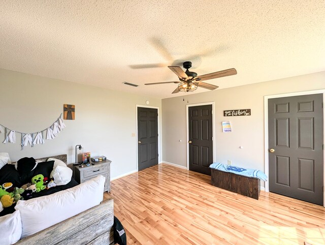 1370 Coach Rd, Slocomb, AL 36375 - bedroom with wood finished floors, a textured ceiling, and ceiling fan