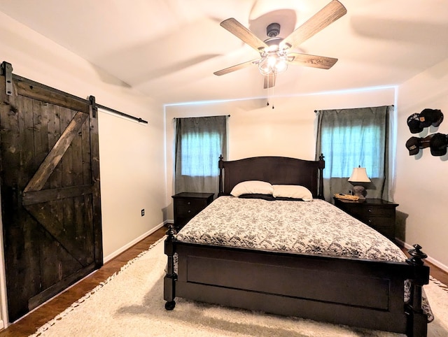 1370 Coach Rd, Slocomb, AL 36375 - bedroom with a barn door and a ceiling fan