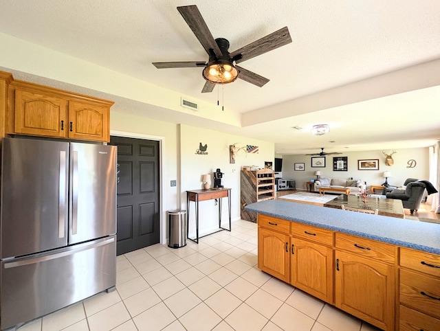 1370 Coach Rd, Slocomb, AL 36375 - kitchen with freestanding refrigerator, ceiling fan, open floor plan, brown cabinets, and light tile patterned floors