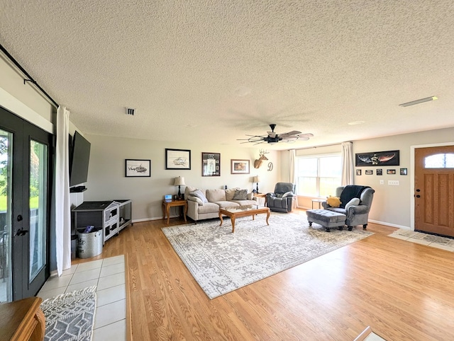 1370 Coach Rd, Slocomb, AL 36375 - living area featuring a textured ceiling, light wood-style floors, and ceiling fan