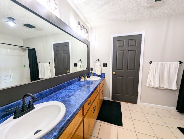 1370 Coach Rd, Slocomb, AL 36375 - bathroom featuring a textured ceiling, double vanity, tile patterned floors, and a shower with curtain