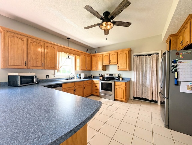 1370 Coach Rd, Slocomb, AL 36375 - kitchen with appliances with stainless steel finishes, ceiling fan, a textured ceiling, dark countertops, and light tile patterned flooring