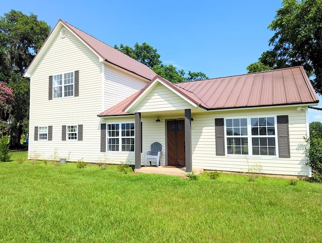 1370 Coach Rd, Slocomb, AL 36375 - view of front of house with a metal roof and a front lawn