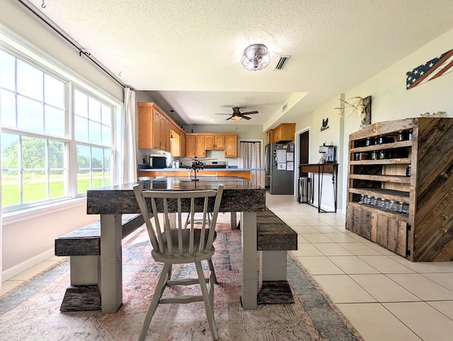 1370 Coach Rd, Slocomb, AL 36375 - dining room featuring light tile patterned flooring, ceiling fan, and a textured ceiling
