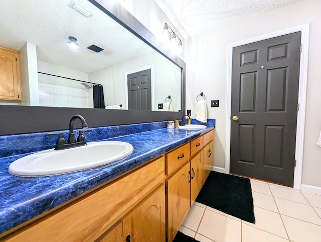 1370 Coach Rd, Slocomb, AL 36375 - bathroom featuring double vanity, a textured ceiling, tile patterned flooring, and curtained shower