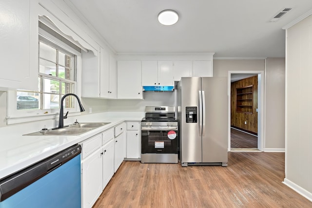 139 Merrydell Dr, Ozark, AL 36360 - kitchen featuring stainless steel appliances, light wood-style floors, light countertops, under cabinet range hood, and white cabinets