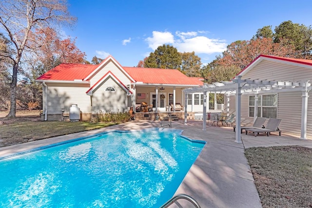 view of pool with ceiling fan, a patio area, and a pergola