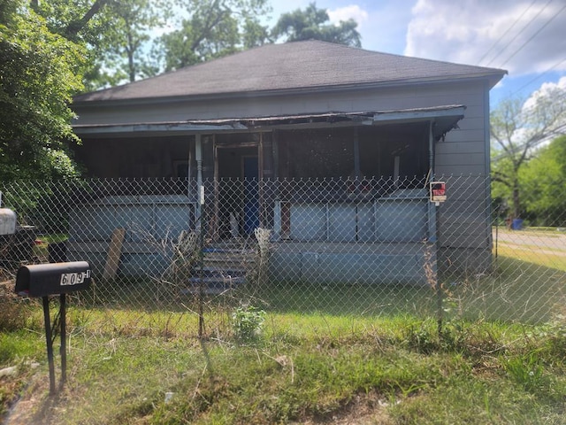 view of front of house featuring fence and a shingled roof
