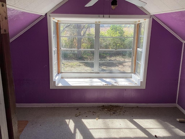 additional living space with vaulted ceiling, carpet, and ceiling fan