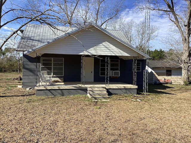 bungalow with covered porch and metal roof