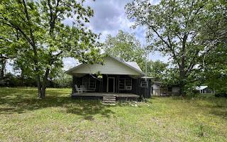 rear view of property with a lawn