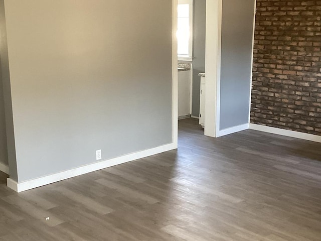 unfurnished room with dark wood-type flooring