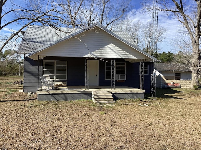 bungalow featuring a porch and metal roof