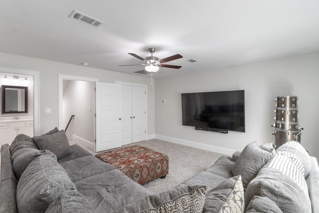 carpeted living room with ceiling fan