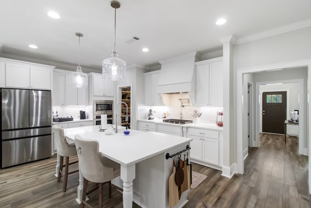 kitchen featuring white cabinets, custom range hood, and stainless steel appliances