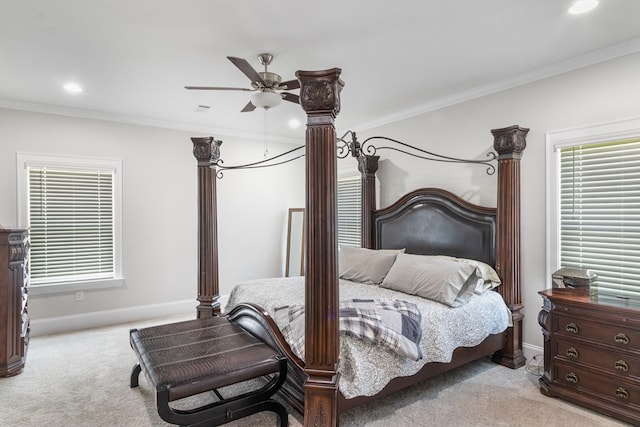 carpeted bedroom featuring ceiling fan and crown molding