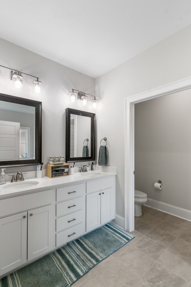 bathroom featuring tile patterned floors, vanity, and toilet