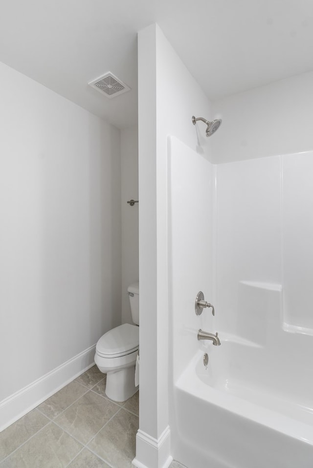 bathroom featuring tile patterned floors, shower / bathing tub combination, and toilet