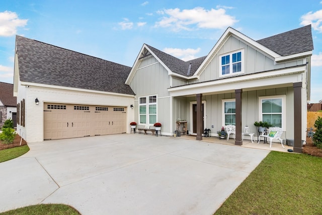 view of front of home featuring covered porch and a garage