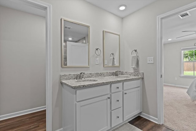 630 Ridgeland Rd, Dothan, AL 36301 - bathroom with double vanity, wood finished floors, and ensuite bathroom