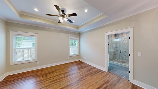 unfurnished room featuring ornamental molding, hardwood / wood-style flooring, and a healthy amount of sunlight