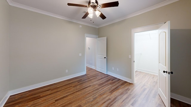 unfurnished bedroom featuring hardwood / wood-style flooring, ceiling fan, and ornamental molding