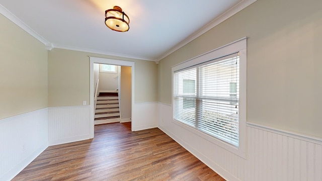 spare room with crown molding and dark wood-type flooring