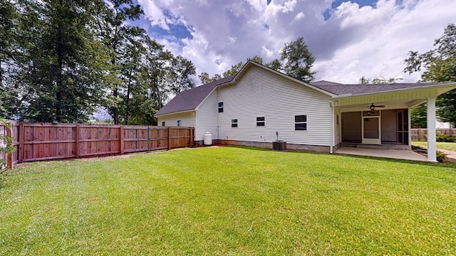 rear view of house with a yard, cooling unit, ceiling fan, and a patio area