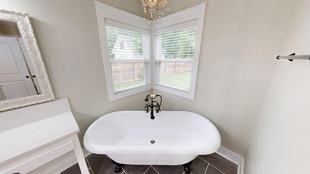 bathroom with tile patterned floors and a tub to relax in