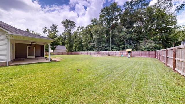 view of yard featuring ceiling fan and a patio