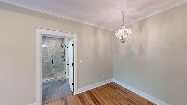 unfurnished room with hardwood / wood-style flooring, ornamental molding, and a chandelier