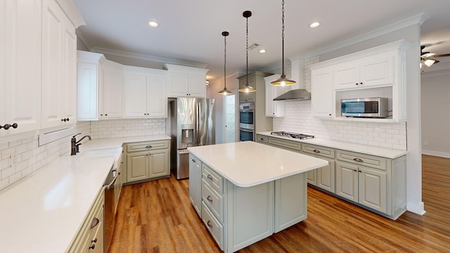 kitchen featuring pendant lighting, a center island, white cabinets, and stainless steel appliances