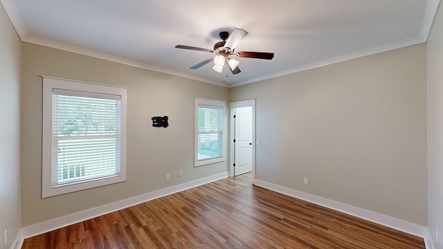 unfurnished room featuring wood-type flooring, plenty of natural light, and crown molding