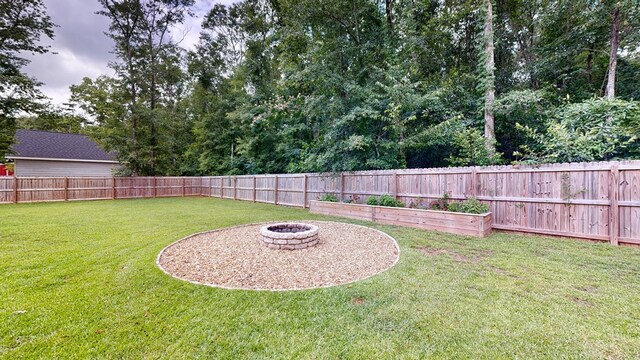 view of yard with a fire pit