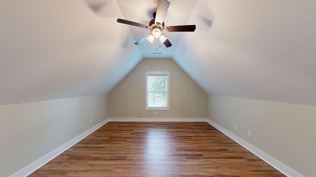 bonus room featuring dark hardwood / wood-style floors, vaulted ceiling, and ceiling fan