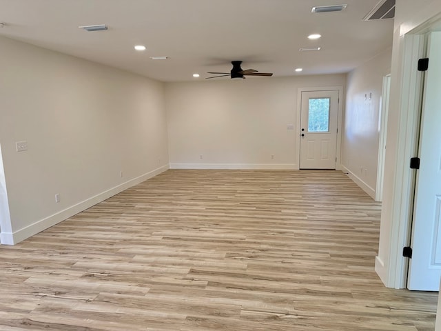 empty room with light hardwood / wood-style floors and ceiling fan