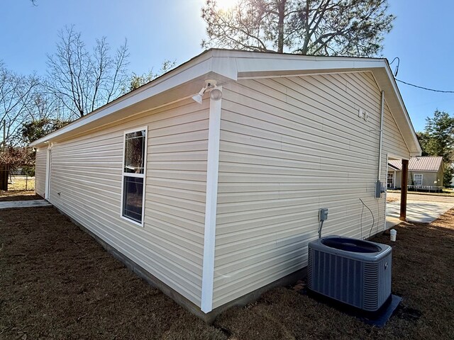 view of side of home featuring central AC unit