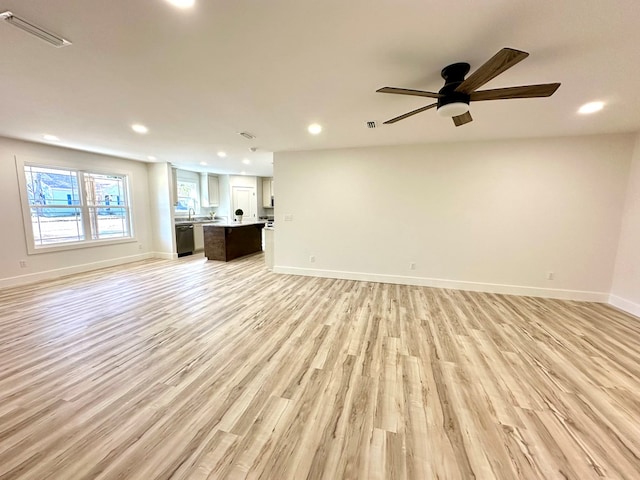 unfurnished living room featuring light wood-type flooring and ceiling fan