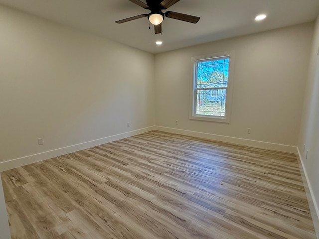 unfurnished room with ceiling fan and light hardwood / wood-style flooring