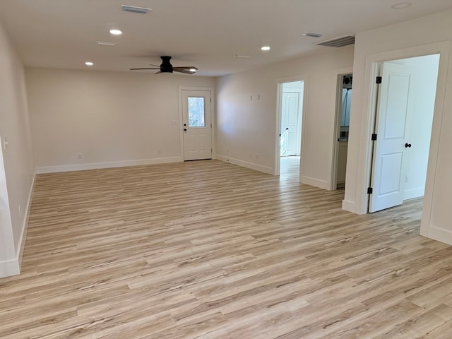 empty room featuring ceiling fan and light hardwood / wood-style floors