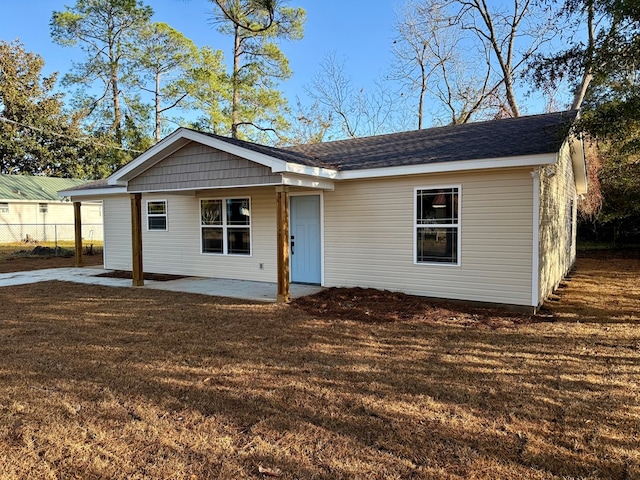 ranch-style house featuring a patio and a front lawn