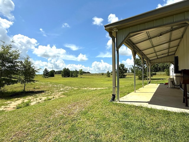245 County Road 422, Abbeville, AL 36310 - view of green lawn with a patio and a rural view