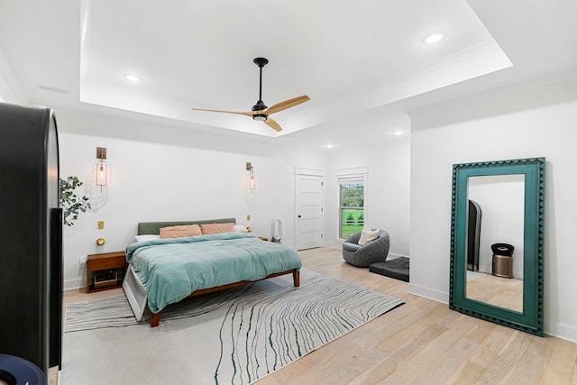 481 Grace Dr, Newton, AL 36352 - bedroom with a tray ceiling, crown molding, freestanding refrigerator, light wood finished floors, and recessed lighting